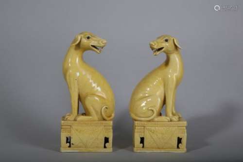 A PAIR OF CHINESE YELLOW GLAZED HOUNDS.