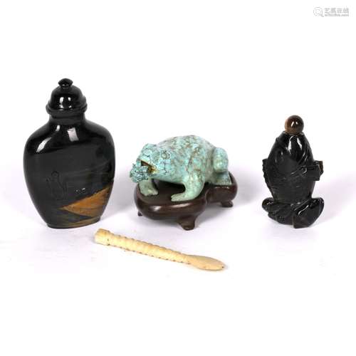 Tigers eye snuff bottle Chinese carved with figures to the centre with vases, 6cm high, a smaller