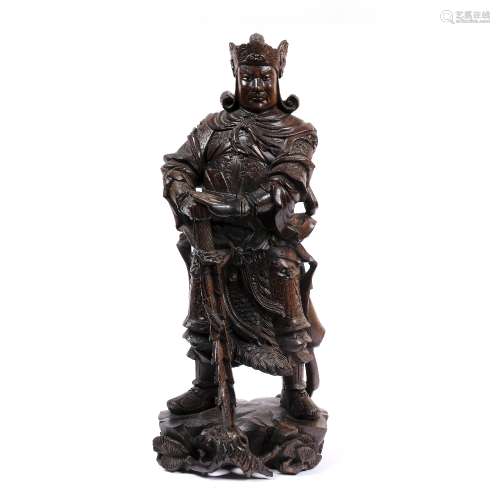 Tall hardwood figure of a standing warrior Chinese, late 19th Century carrying a sword, 56.5cm high