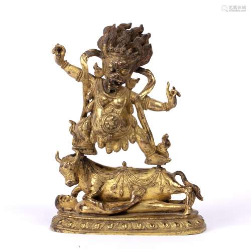 Gilt bronze figure of Yamantaka Tibetan, 19th Century with two arms outstretched, standing on a bull