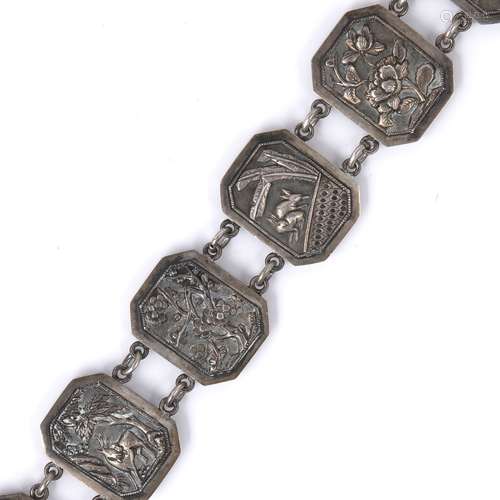 White metal link belt Chinese, circa 1920 with fifteen embossed panels depicting temples, dragons