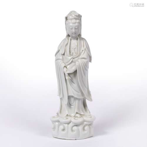 Blanc de chine standing figure of Guanyin Chinese, early 19th Century heavily potted, on a wave