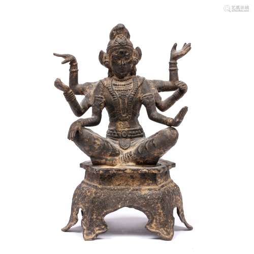 Cast metal model of a deity Tibetan with six arms in various poses, on a raised base, 23.5cm high