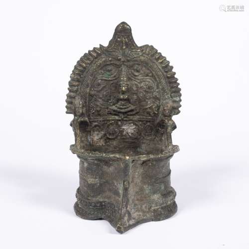Bronze oil burner Nepal, 19th Century with a central deity to the centre, the bottom well modelled