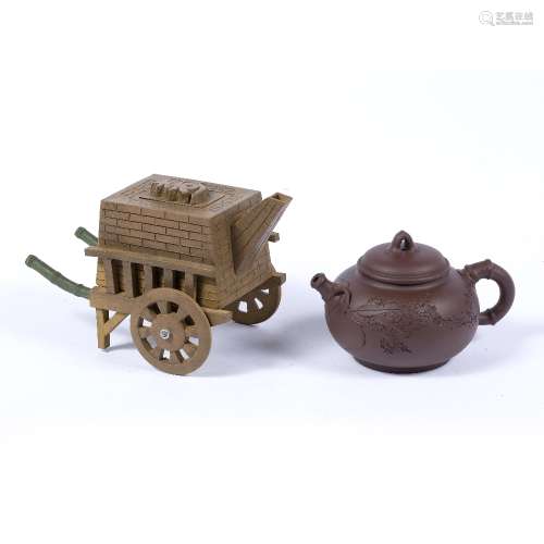 Two Yixing teapots and covers Chinese, 20th Century one in duanni clay in the form of a cart of clay