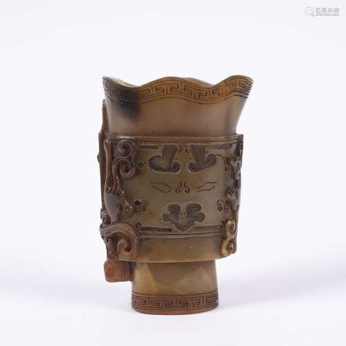 Flattened oviform horn libation cup Chinese, 19th Century carved as an archaic bronze with two chi-