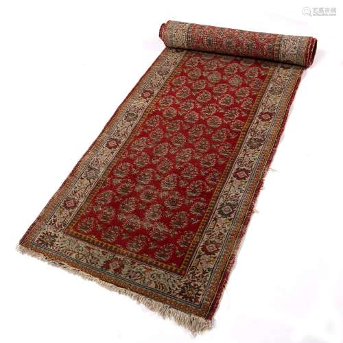 Red ground runner Indian with boteh designs within a foliate border, 308cm x 71cm