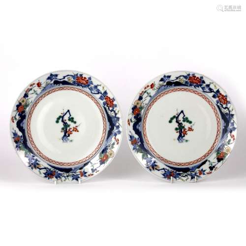 Pair of Kakiemon style large plates Japanese, Edo period each with central blossom and pine within a