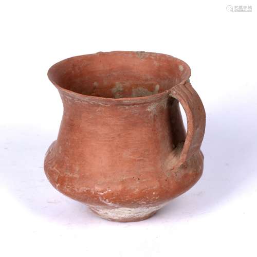 Pottery beaker Chinese, possibly Neolithic period with a bulbous body and looped handle, 11cm high