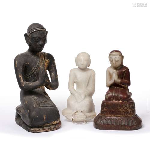 Three kneeling models of monks Burmese, 19th Century including two marble examples, on part