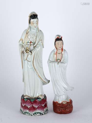 Two porcelain models of Guanyin Chinese the largest holding an object to one hand, standing on a