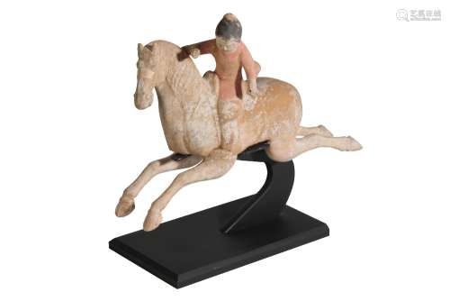 PAINTED POTTERY FIGURE OF A FEMALE POLO PLAYER, MING DYNASTY