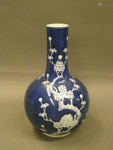 CHINA Porcelain vase with white branch decoration on a blue background. H. : 30,5cm