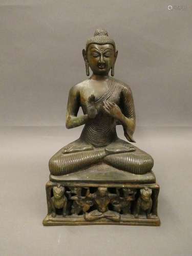 SOUTHEAST ASIA Deity sitting in bronze with green patina. Ht: 32cm