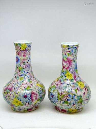 CHINA Pair of long neck porcelain vase with polychrome floral decoration. Marked on the reverse side