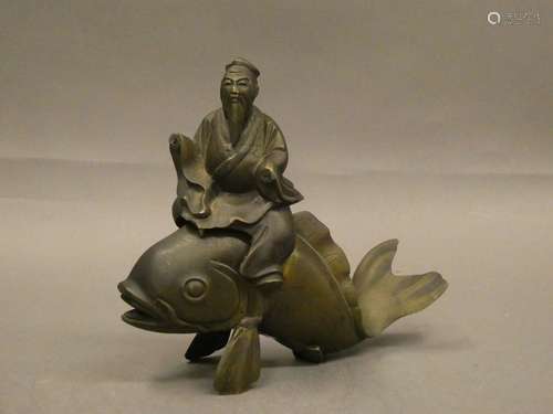 CHINA Bronze perfume burner featuring a figure sitting on a carp. H. : 16 cm