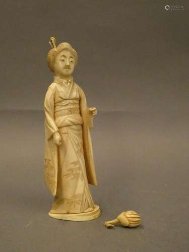 Bone okimono depicting a woman holding a flower in her hand. H. :17cm