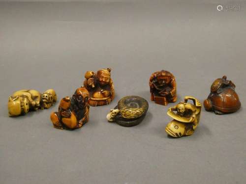 CHINA Set of seven netsuke including a lying dog, turtle, coiled snake, characters and fish.