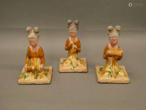 CHINA Ensemble of three enamelled terracotta musicians. Ht: 19cm