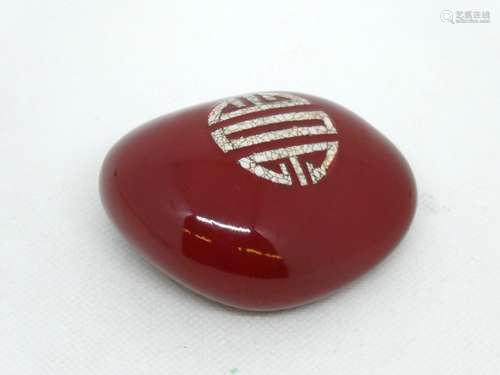 CHINA Polished and enamelled pebble with caligraphic pattern