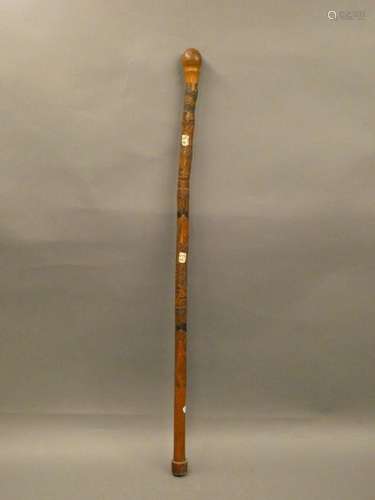 JAPAN Wooden cane carved with landscapes and men's heads made of bone. Meiji period