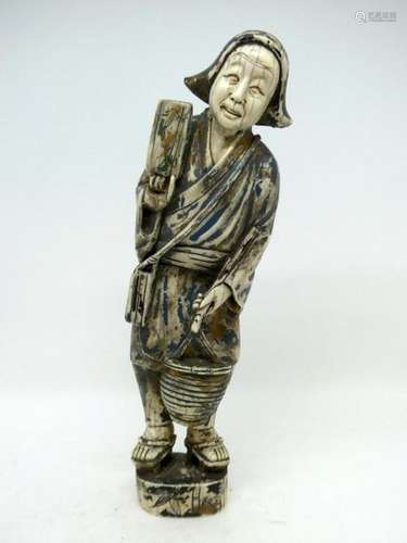 JAPAN around 1900 Ivory subject depicting a man carrying a basket. Traces of polychromy. Ht : 24cm