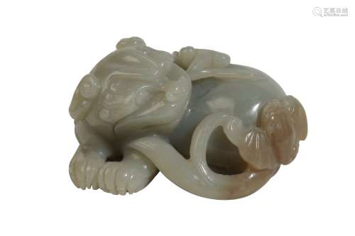 CELADON JADE CARVED FIGURE OF A LION DOG