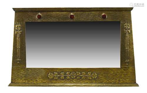 An Arts and Crafts brass framed over-mantel mirror with ceramic insets c.1905 The wood frame covered