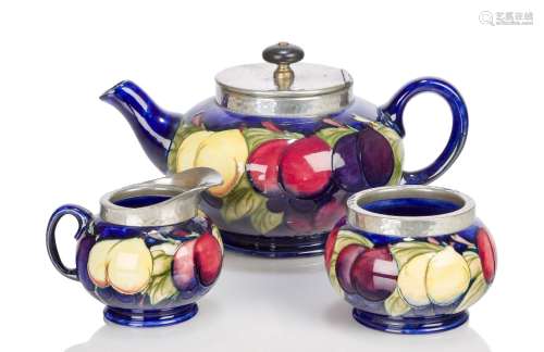 William Moorcroft (1872-1945), a pewter mounted earthenware 'Wisteria' pattern tea set c.1925,