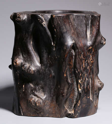 A RED WOOD BRUSH POT NATURE SHAPED