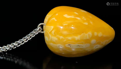 A BEESWAX PENDANT SHAPED WITH HEART