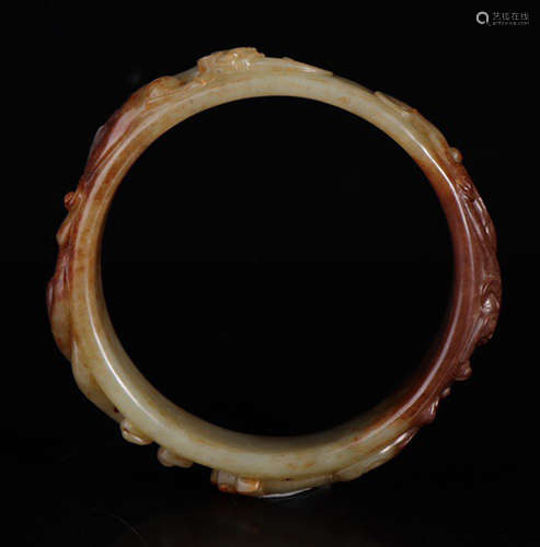 A HETIAN JADE BANGLE CARVED WITH BEAST