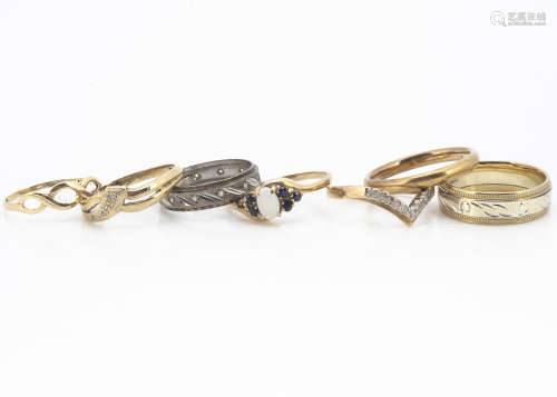 Seven 9ct gold dress rings, including an opal and sapphire example, diamond wishbone, three bands