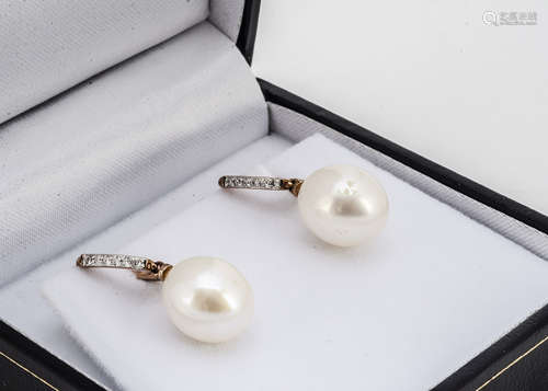 A pair of cultured pearl and diamond drop earrings, with Omega fastenings, 2.5cm drop, boxed,