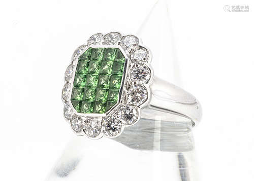 A tsavorite and diamond tablet dress ring, of tablet shape with pave set green garnets surrounded by