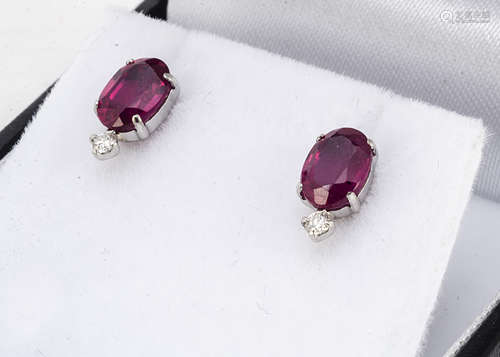 A pair of platinum ruby and diamond ear studs, the oval mixed cut rubies surmounted by brilliant cut