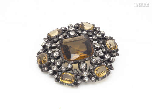 A late 19th/early 20th Century paste set simulated smoky quartz brooch of circular design set in