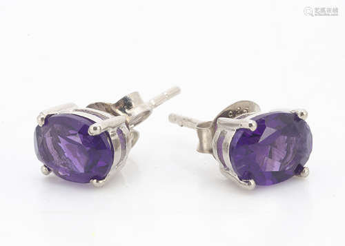 A pair of amethyst oval mixed cut silver set ear studs