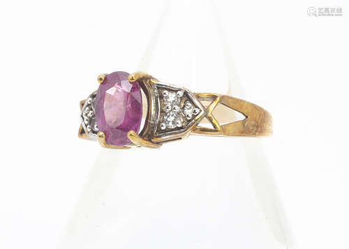 A ruby, diamond and white topaz dress ring, the oval ruby in claw setting flanked by colourless