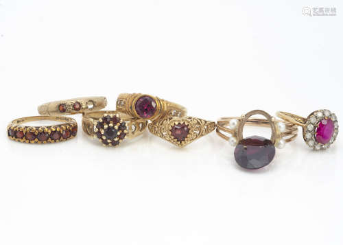 A collection of seven garnet set dress rings, some with vacant settings, one with missing claw,