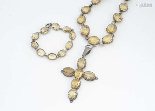 A continental white metal and citrine cross pendant and chain, the oval citrines set in fleur de lys