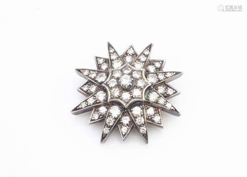 A pre War diamond platinum set star brooch, the eight ray star alternating between smaller rays