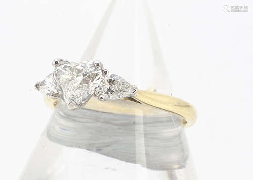 A three stone heart shaped diamond ring, the claw set central heart cut diamond flanked by two