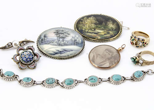 Two Russian mother of pearl miniature painted oval brooches, depicting a winter landscape and wooded