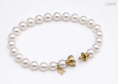 A boxed Mikimoto 18ct gold diamond and cultured pearl bracelet, the white pearls with pink overtones