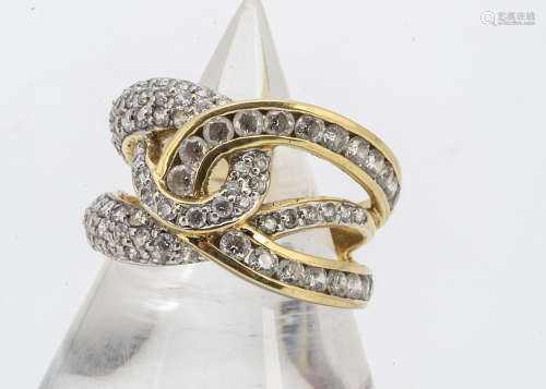 An 18ct gold and white stone set dress ring, the knotted shaped setting set with various white