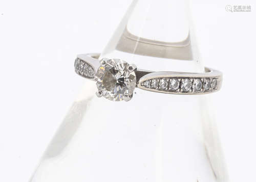 A GIA certificated diamond engagement ring, the brilliant cut in four claw setting with graduated