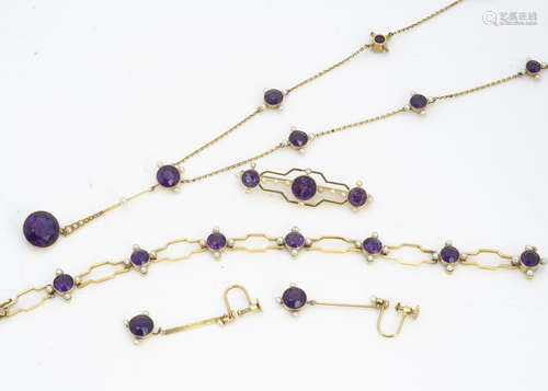 An Edwardian 15ct gold amethyst and seed pearl suite of jewels, comprising a necklace with drop