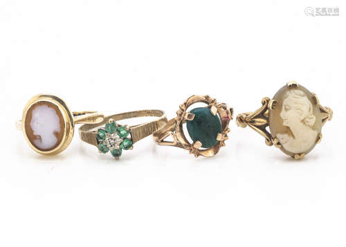 Two 9ct gold cameo rings, an emerald and diamond cluster ring, yellow metal dress ring with stone
