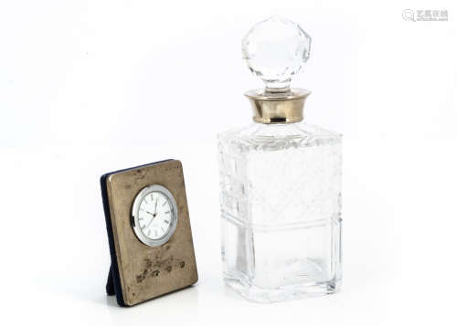 A modern glass and silver collared decanter, together with a modern silver fronted desk clock (2)